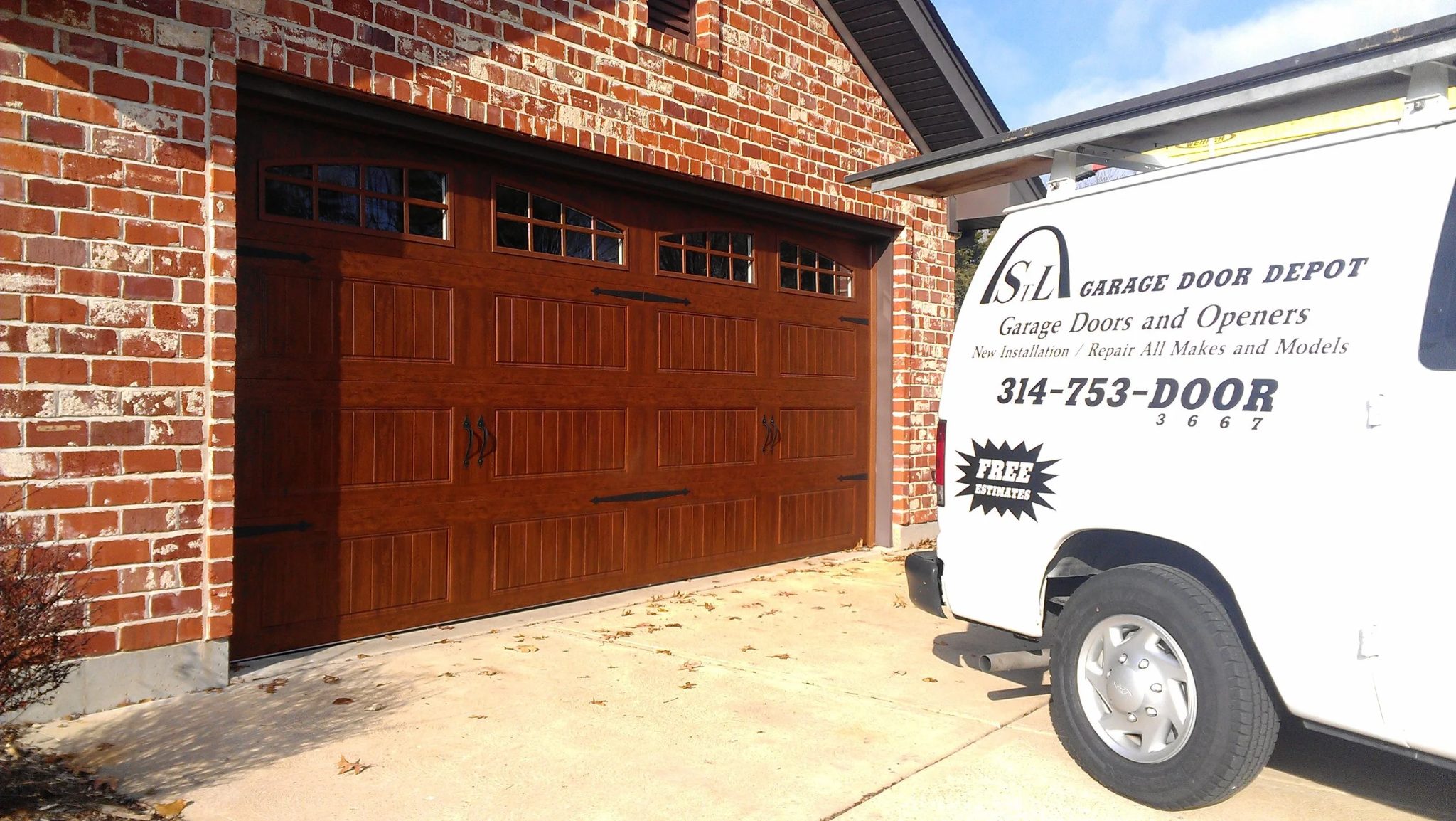 Wood-grain residential garage door with branded service van